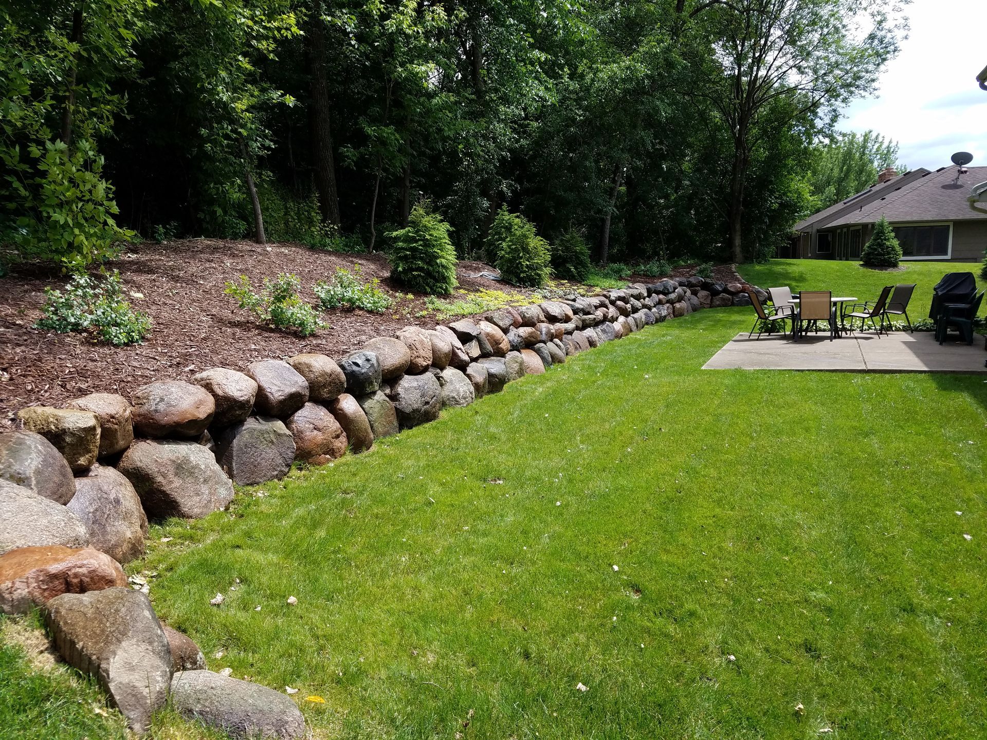 Boulder Retaining Wall | Lawn Care | Mulch Bed