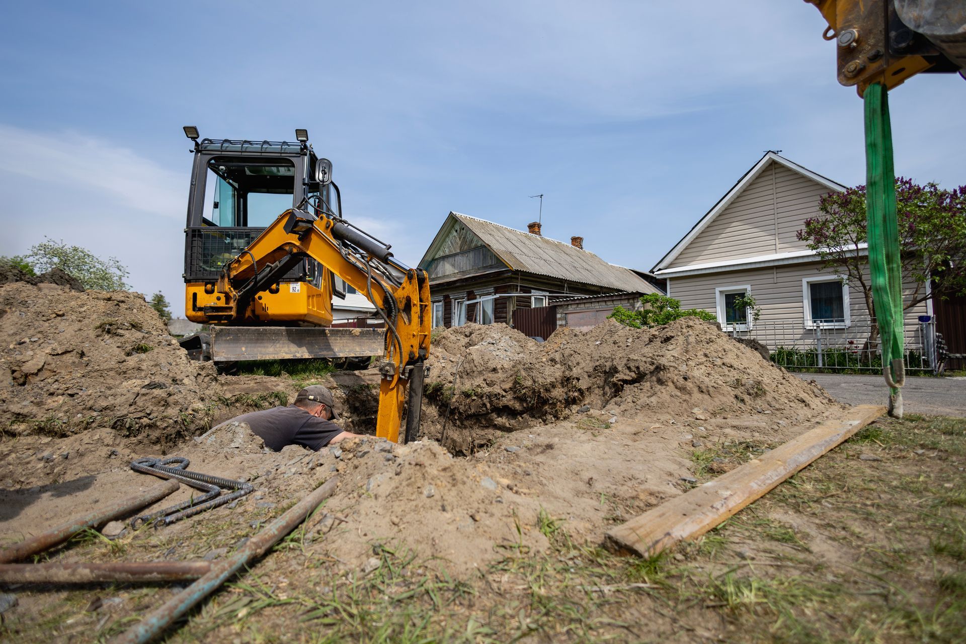 Excavator digging a trench for underground utility or pipeline installation Excavator digging a trench for underground utility or pipeline installation