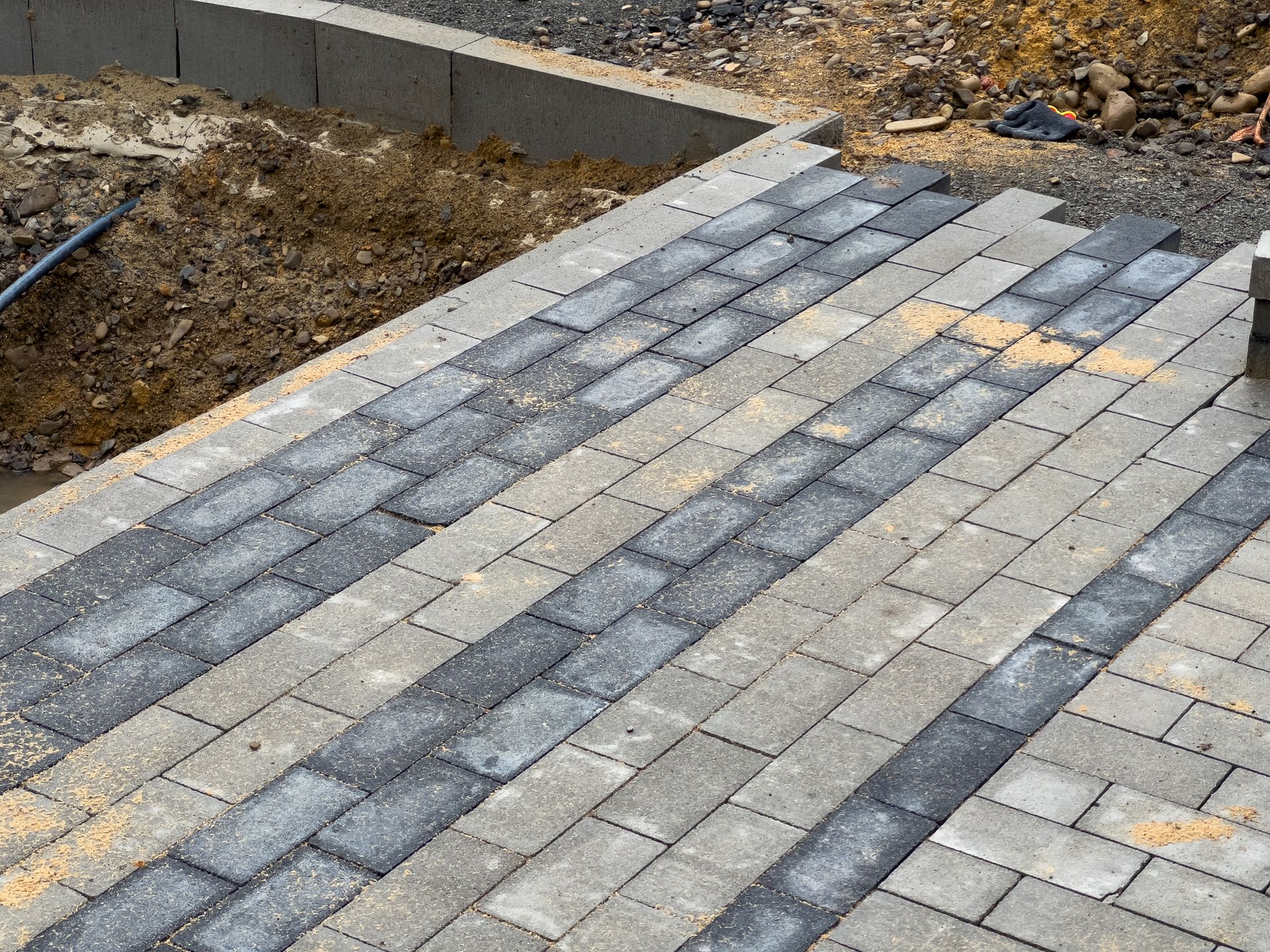 Freshly laid gray pavers create a clean, modern walkway design.
