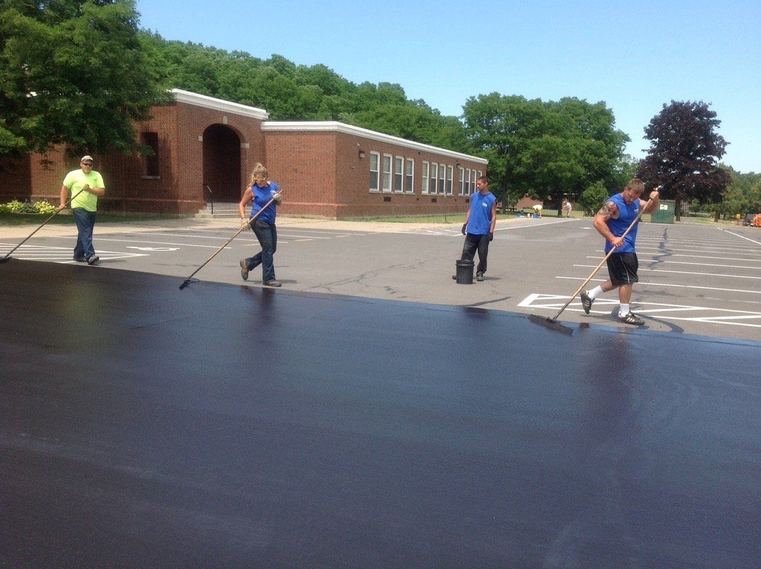 Team Adding Seal Coating — Syracuse, NY — Dependable Paving Co., Inc.