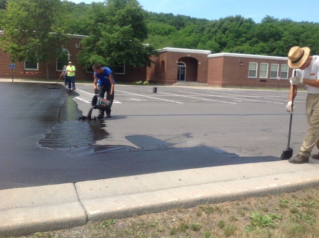 Pouring Seal Coating — Syracuse, NY — Dependable Paving Co., Inc.