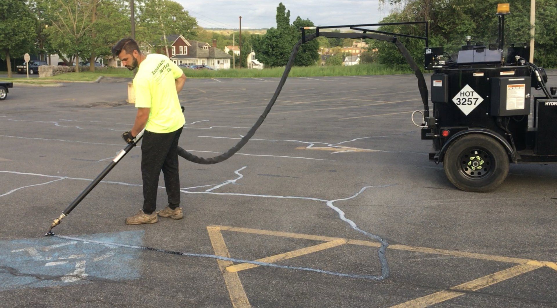 A professional doing residential asphalt sealcoating services in Syracuse, NY