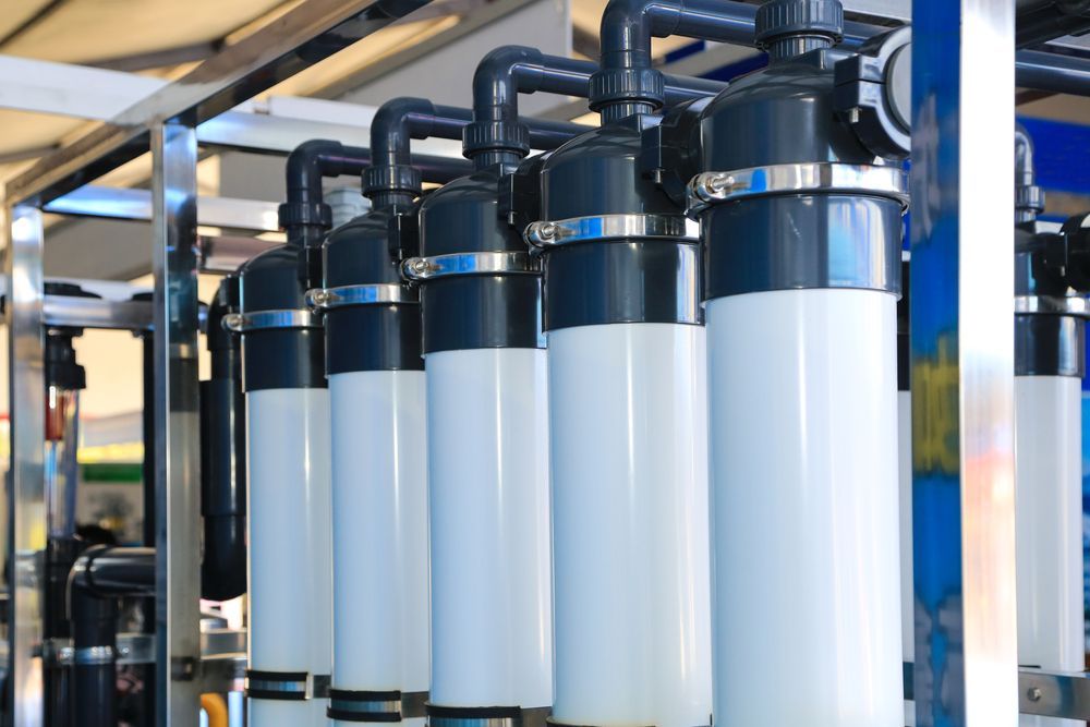 A Row of White and Black Pipes Are Lined Up in a Factory — The Pump Doctor In Kuluin, QLD