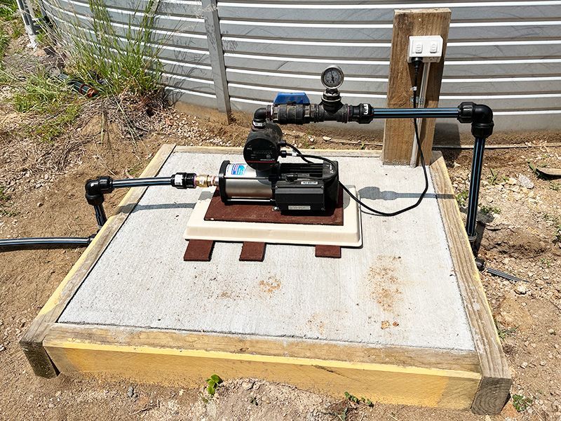 A Water Pump is Sitting on Top of a Wooden Platform — The Pump Doctor In Kuluin, QLD