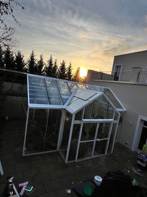 Satteldach Gewächshaus mit Graupe, an einer Seite an haus angebaut. Haupttrakt Größe 4,5x6m, Anbau 3x1m. Komplett aus Echtglas, Gerüst in weißer Farbe.