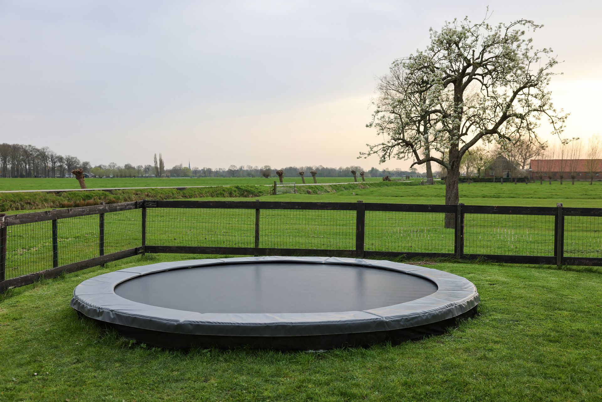 A Round Trampoline In The Middle Of A Lush Green Field — Aiken, NC — Aiken Junkmaster