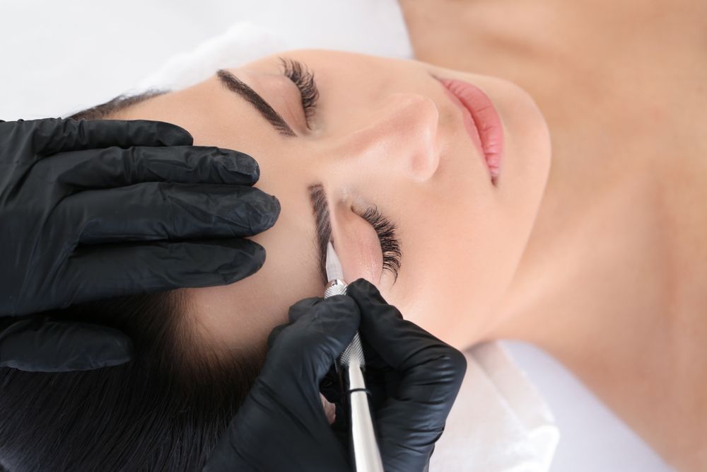 Gloved Hands Applying Eyebrow Makeup โ Villa Nails & Beauty in Cannonvale, QLD