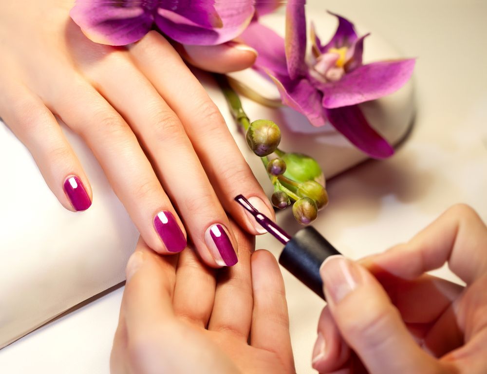 Hands Receiving a Magenta Manicure with Nail Polish Brush β Villa Nails & Beauty in Cannonvale, QLD