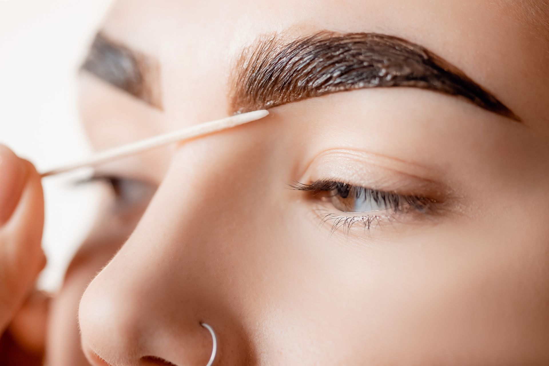 A Woman Eyebrow Being Tinted — Villa Nails & Beauty in Cannonvale, QLD