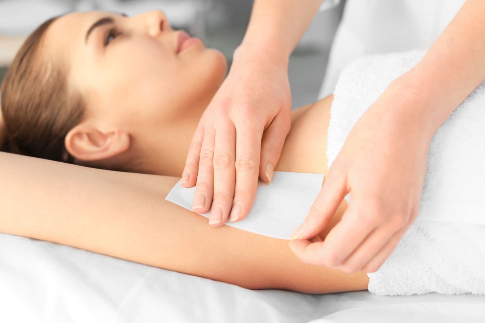 Person Receiving Under Arm Waxing with A White Towel in A Spa — Villa Nails & Beauty in Proserpine, QLD
