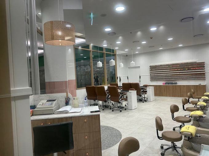 A Large Room with A Lot of Chairs and Tables in A Nail Salon — Villa Nails & Beauty in Cannonvale, QLD