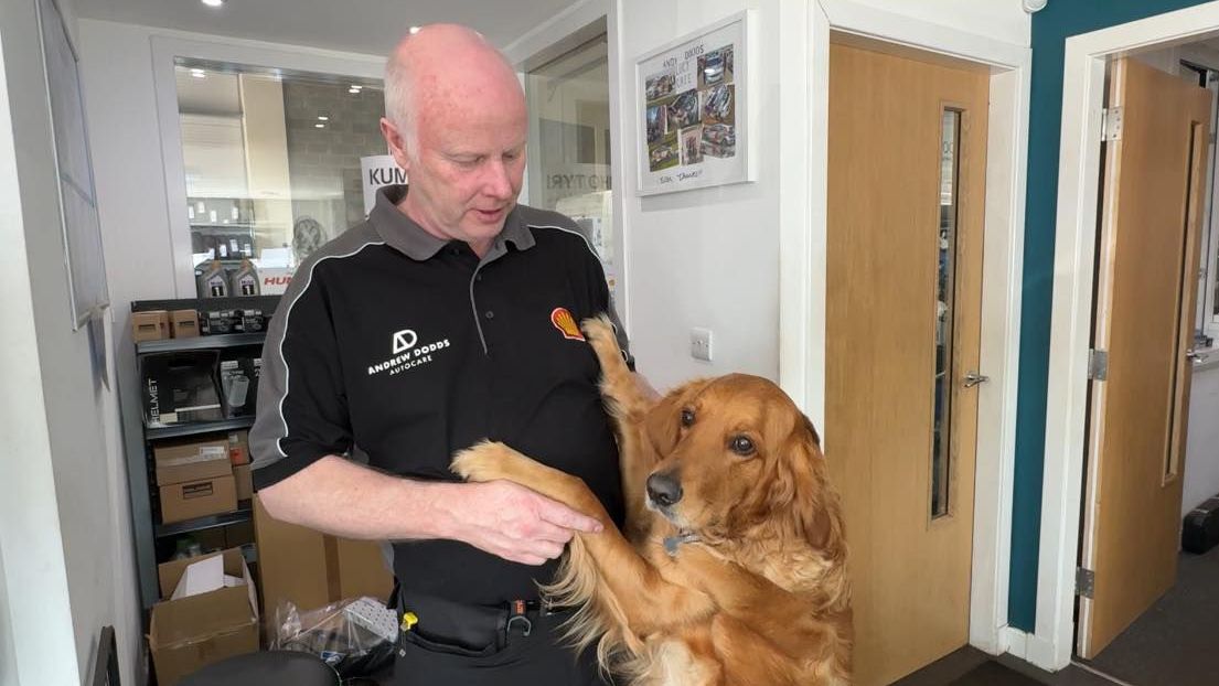 Andy getting a cuddle from dog, Willow