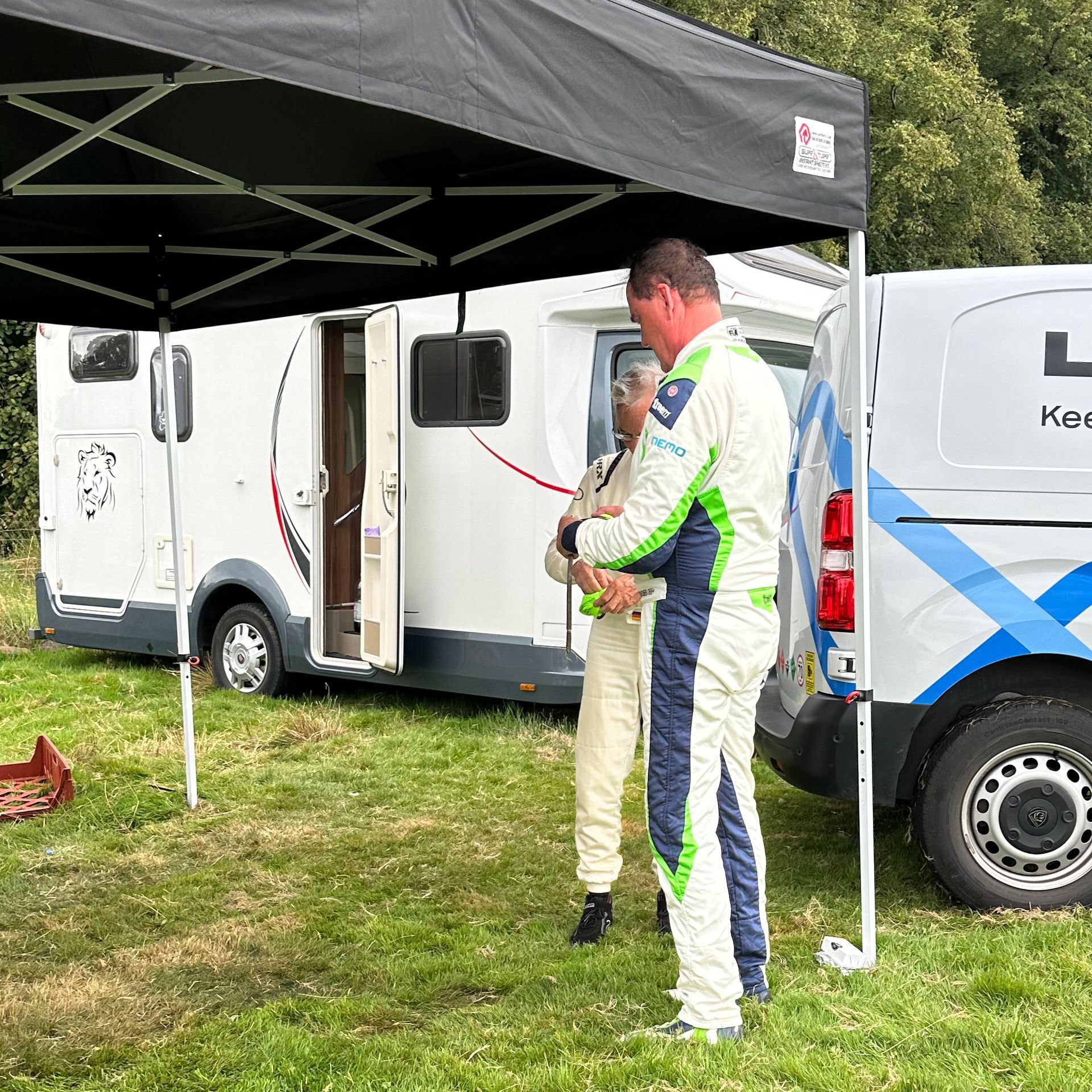 Another rally driver helping dismantle the tent