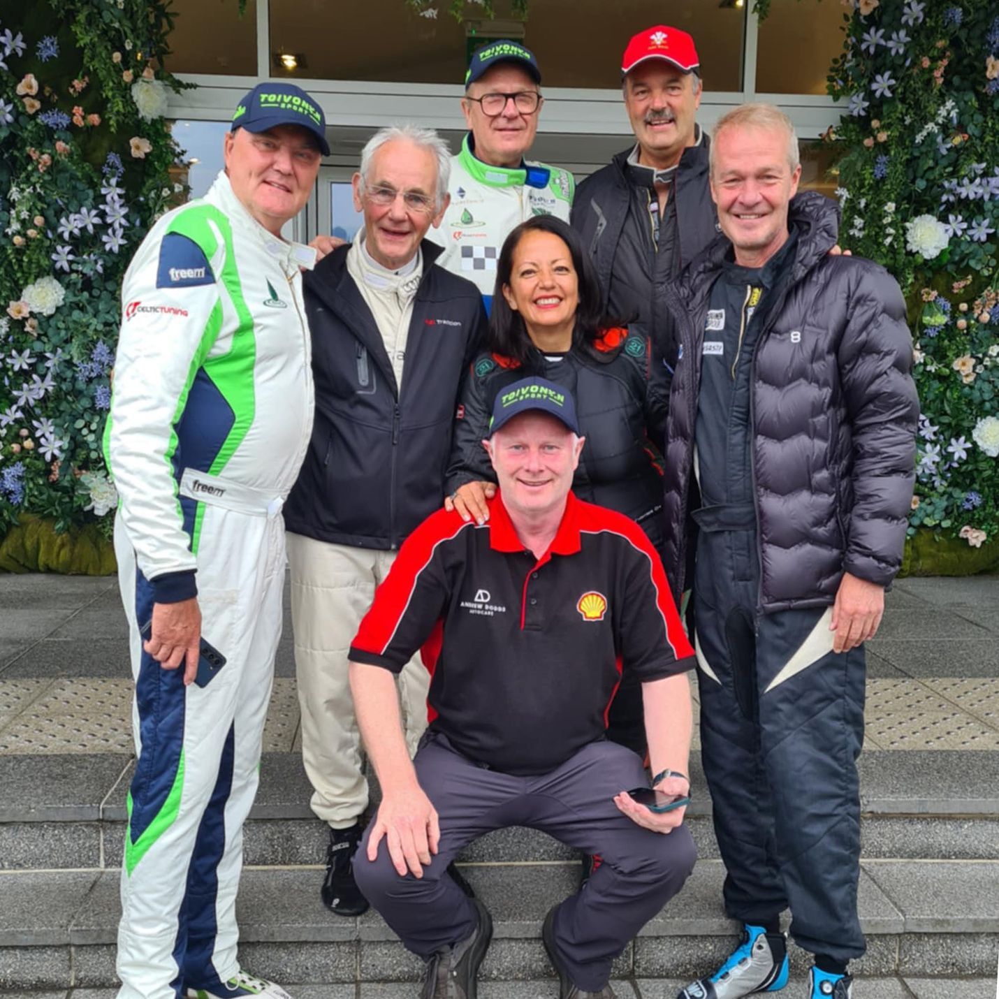 Andrew Dodds smiling with 6 famous rally car drivers