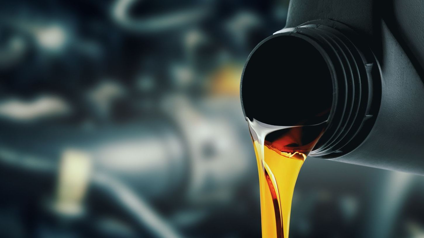 Engine oil being poured into a car