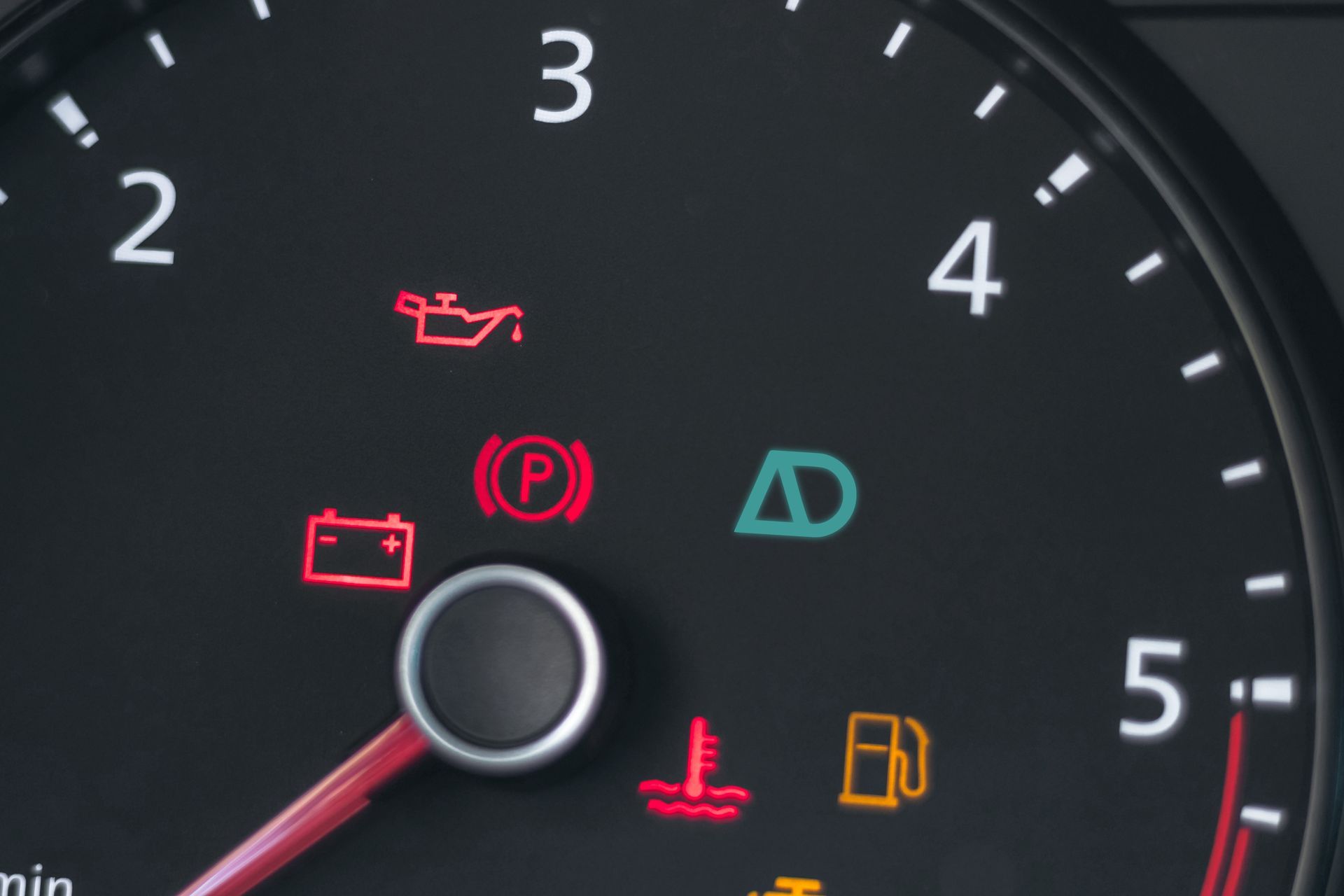 Close up of dashboard with various warning lights