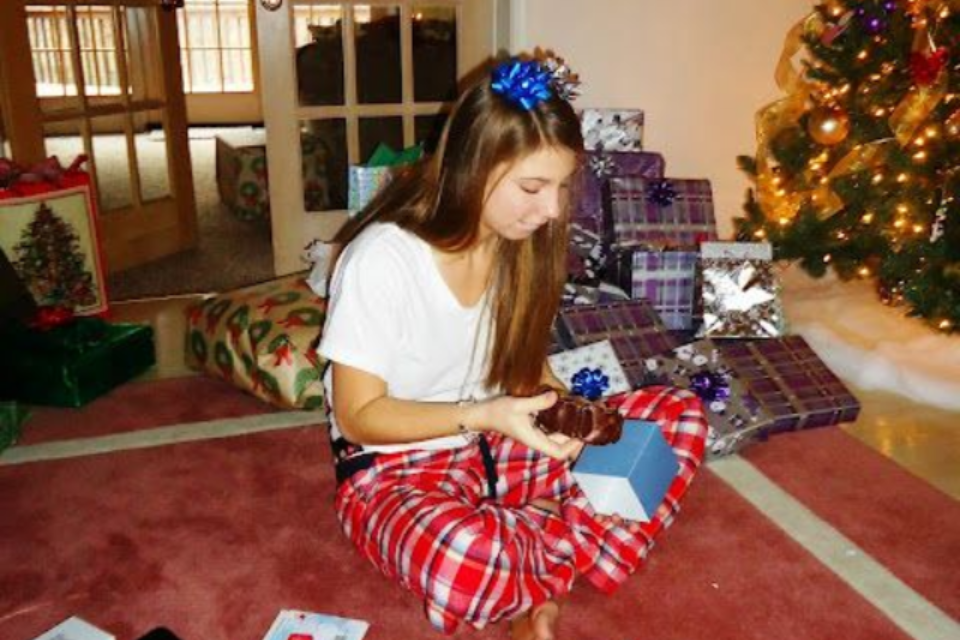 Kelsey Kramer opening Christmas presents