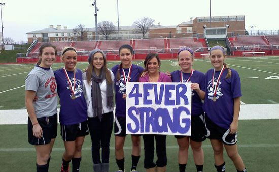 Placeholder Image Soccer players holding a 4 Ever Strong sign in honor of Kelsey Kramer at Owen J. Roberts High School