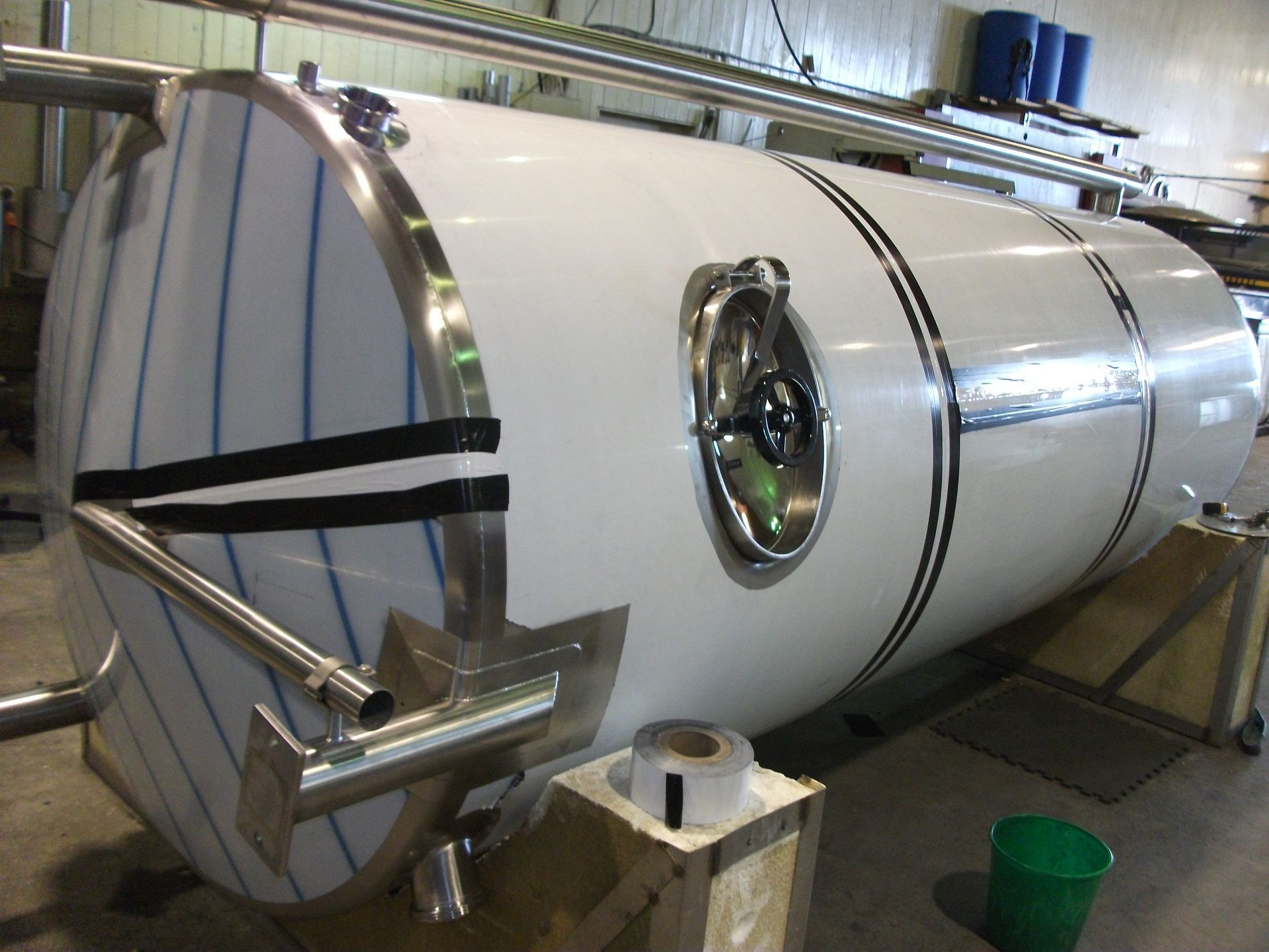 Stainless steel pipes and tanks in a processing facility.