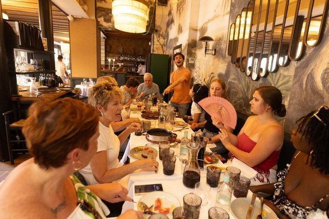 A tour group seated together at a restaurant table in Barcelona