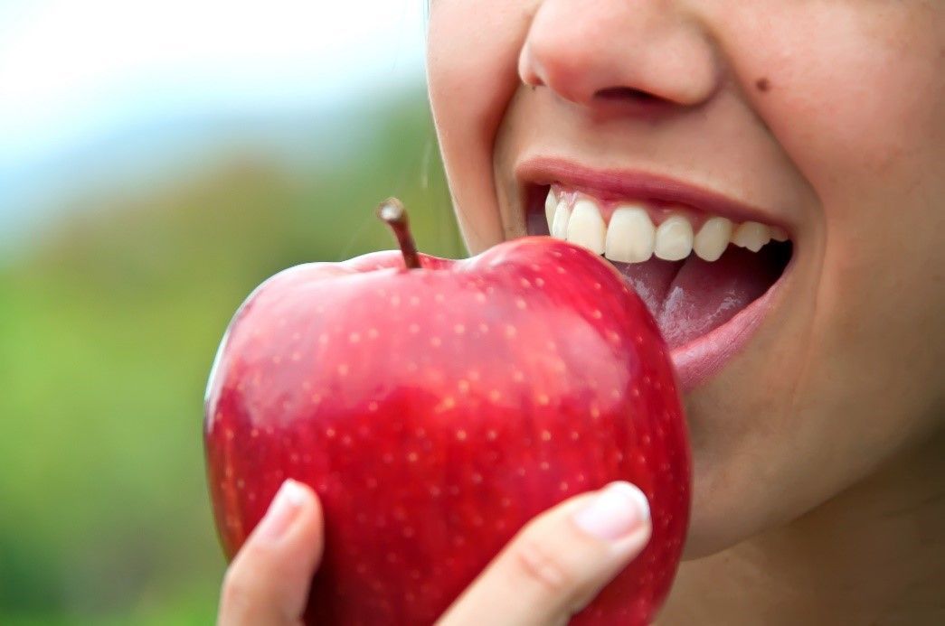 a girl eating an apple