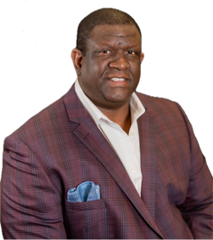 Portrait of a man in a maroon checkered blazer with a blue pocket square against a white background