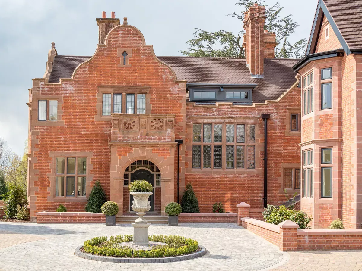 Milverton Hall, A large brick house with a fountain in front of it.