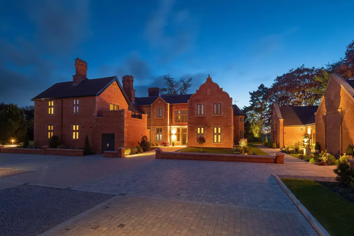 Milverton Hall, A large brick house is lit up at night.