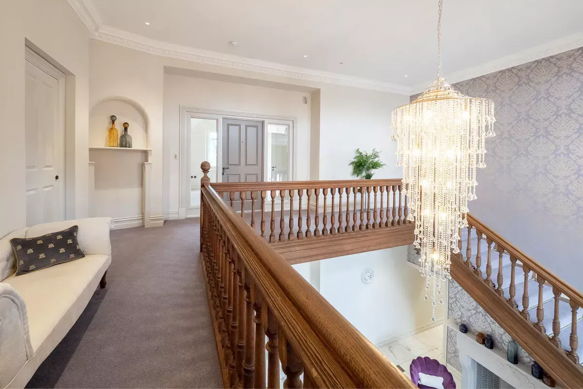 Milverton Hall, A staircase with a chandelier hanging from the ceiling
