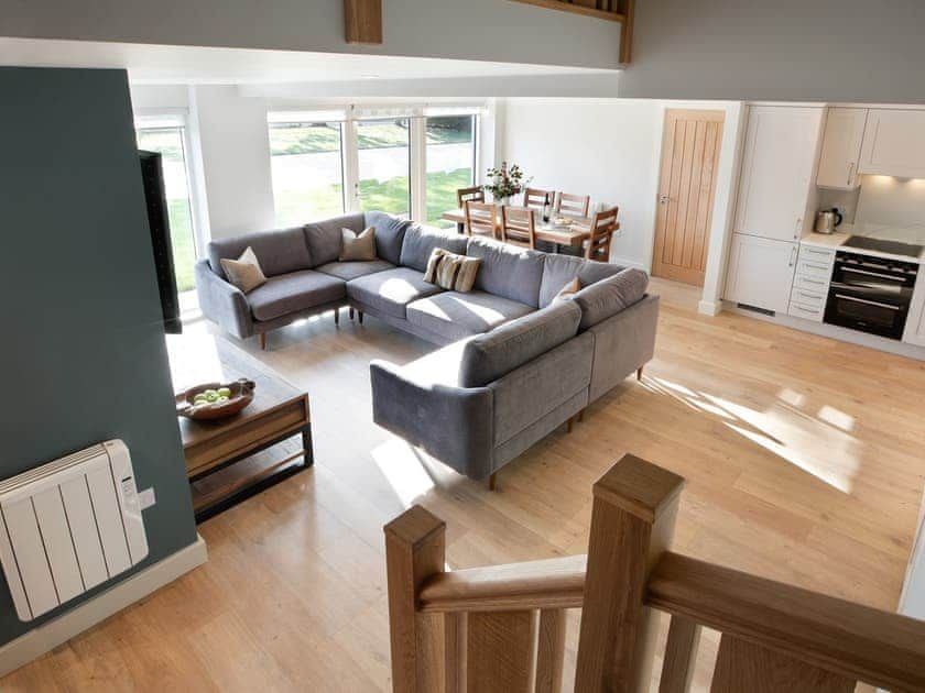Sapphire Barn, A living room with a large sectional couch and a kitchen