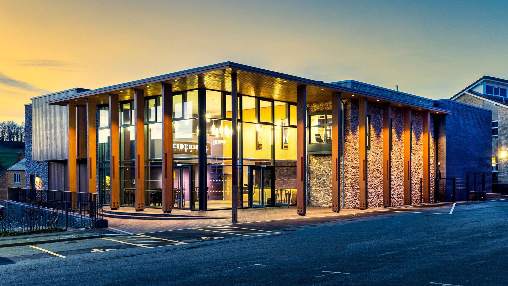 Chipping Campden, A large building with a lot of windows is lit up at night.