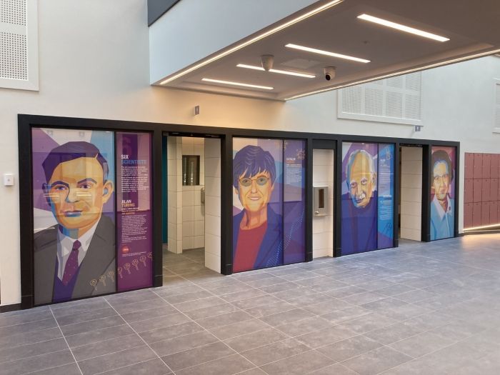 Princethorpe College, A row of doors with portraits of people on them in a building.