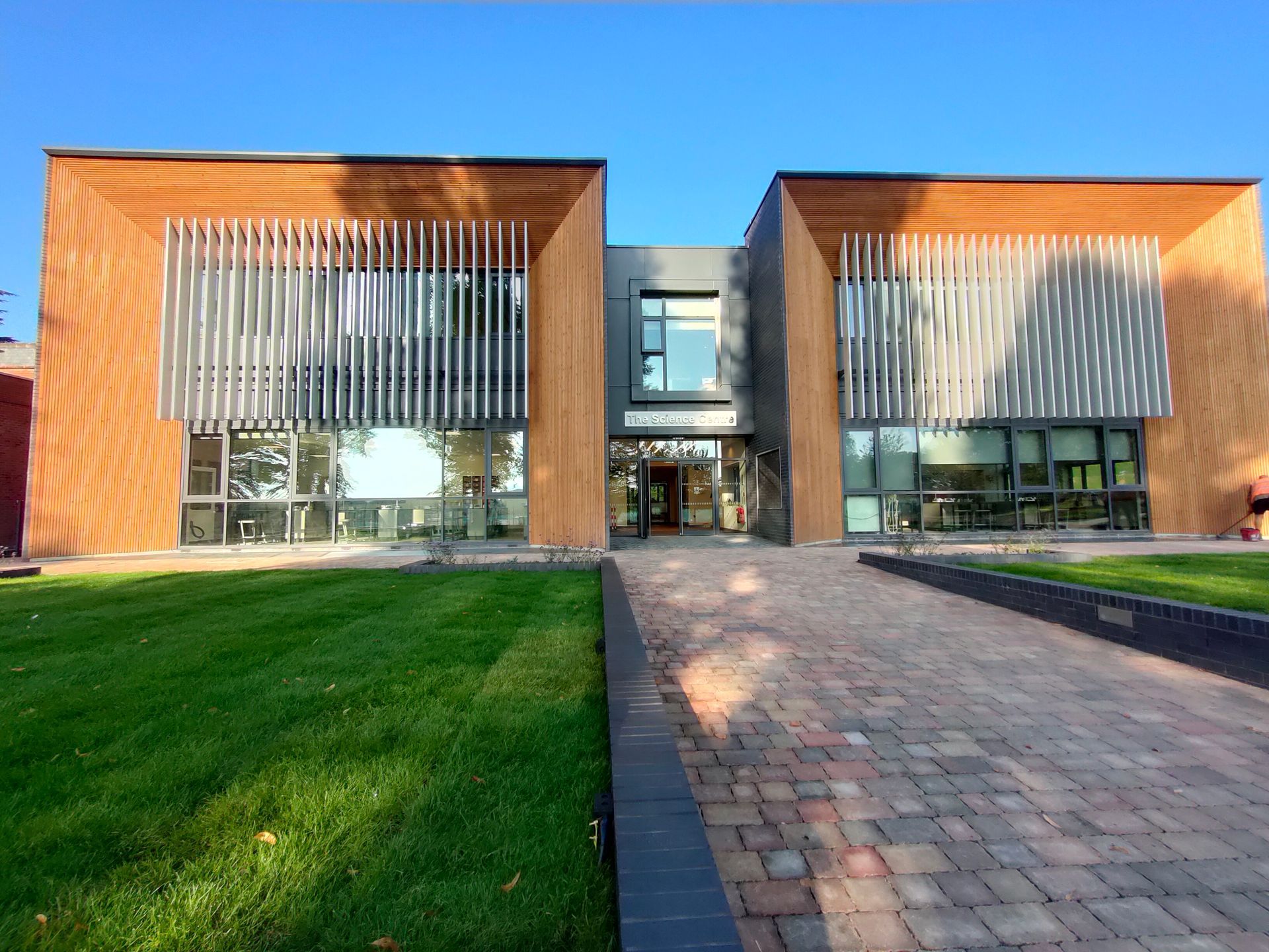 Princethorpe College, A large building with a lot of windows and a brick walkway leading to it.