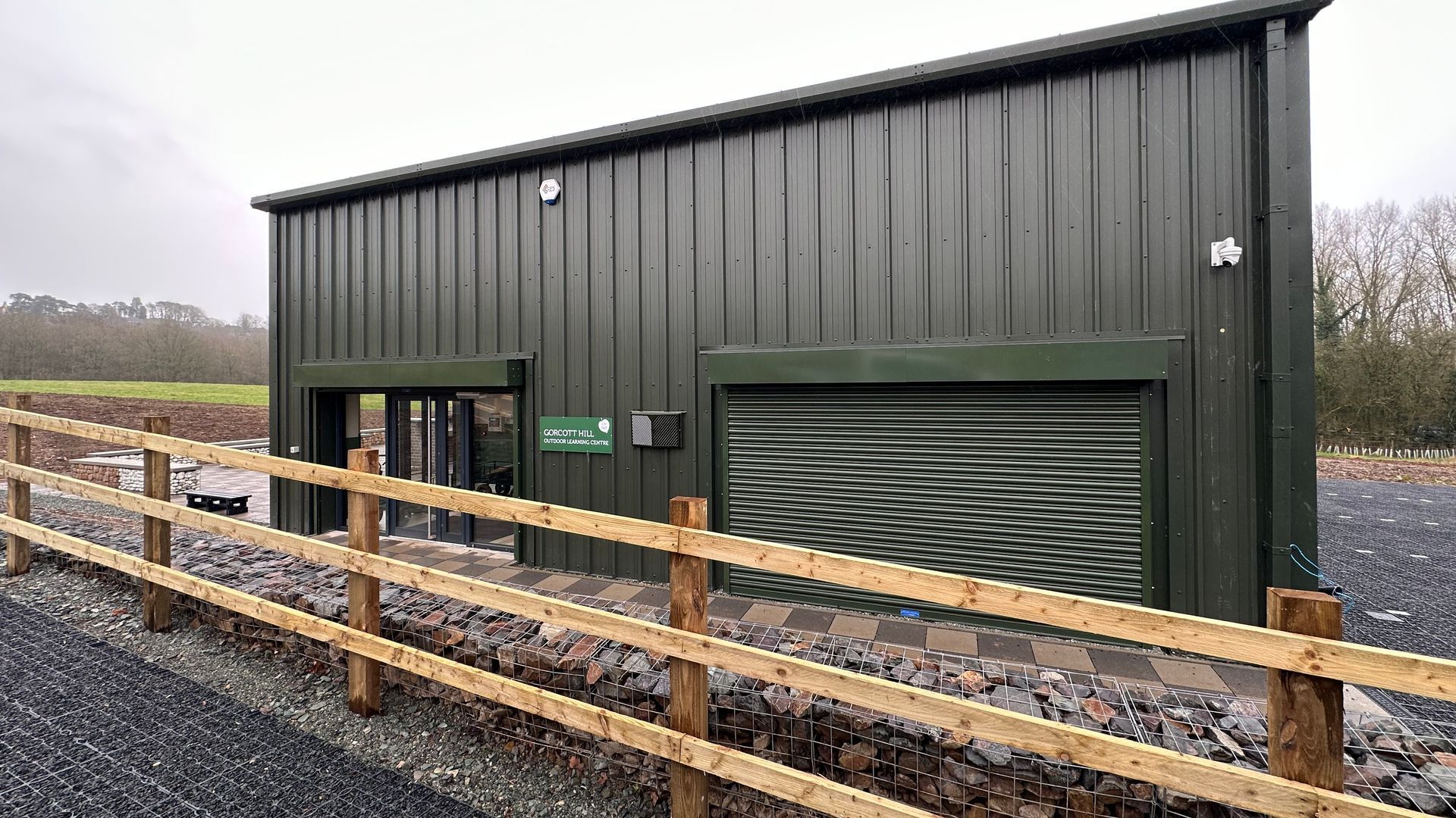 Gorcott Hill, A green metal building with a wooden fence around it.