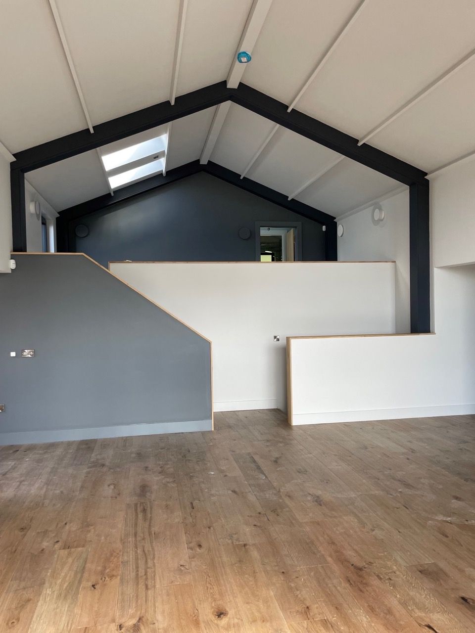 Kingfisher Barn, An empty room with a wooden floor and a vaulted ceiling.