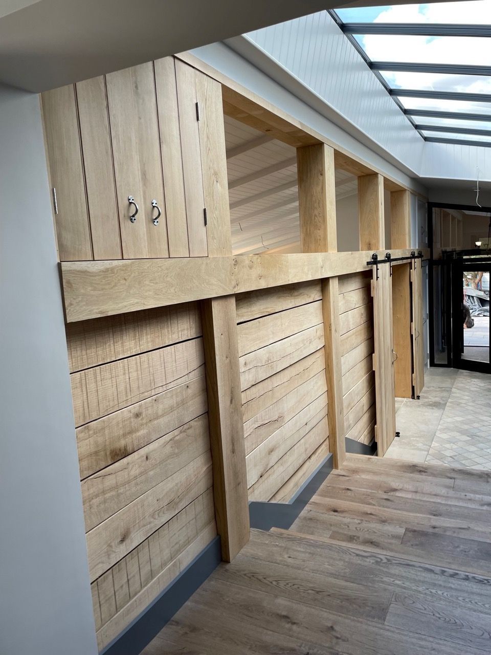 Kingfisher Barn, A long hallway with wooden walls and shelves