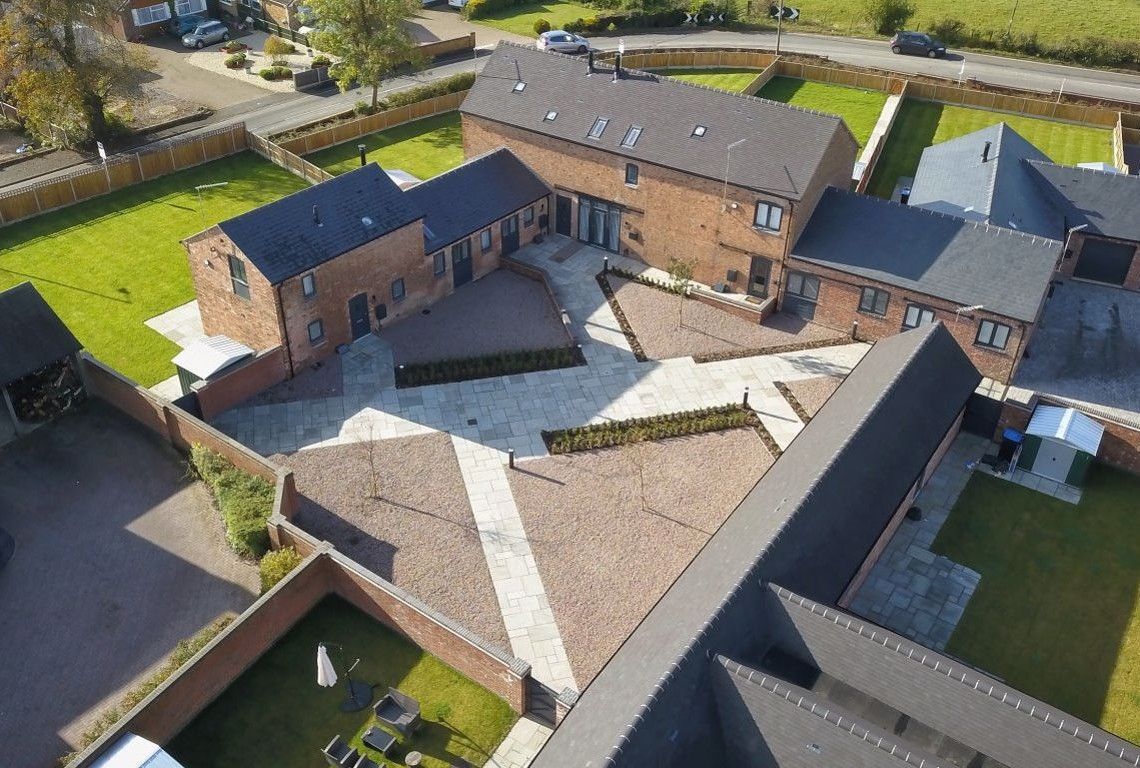 Newbold Farm, an aerial view of a residential area with a lot of houses and gardens.
