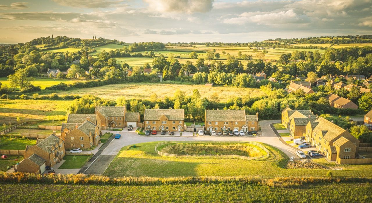 Brailes, An aerial view of a residential area surrounded by fields and trees.