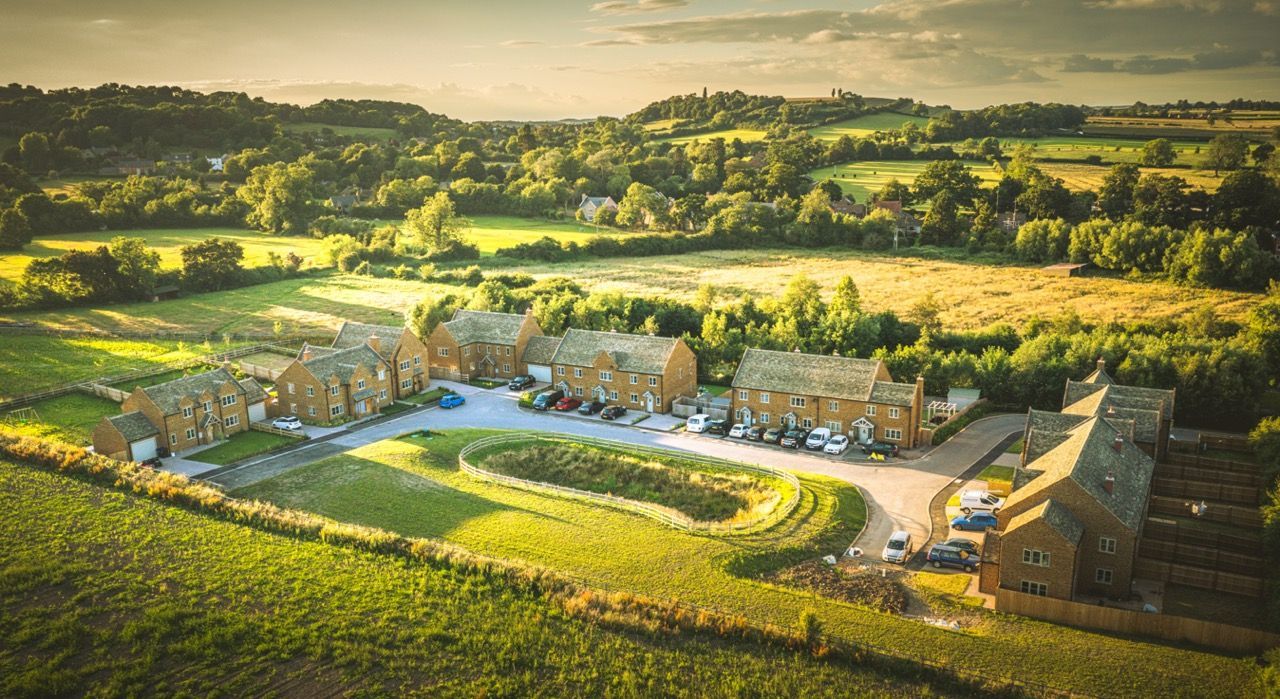 Brailes, An aerial view of a residential area surrounded by fields and trees.