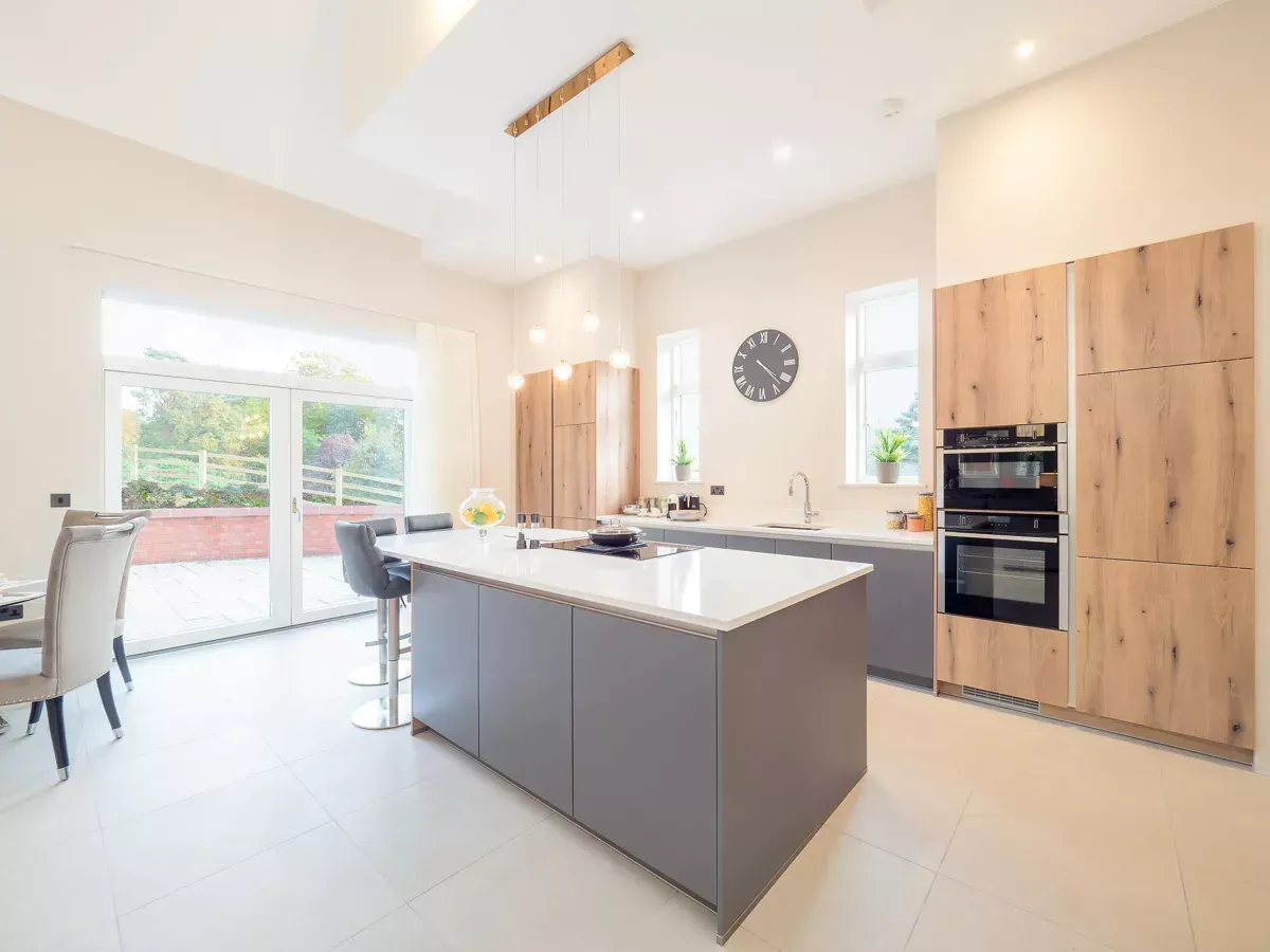 Milverton Hall, A kitchen with a large island and a clock on the wall.