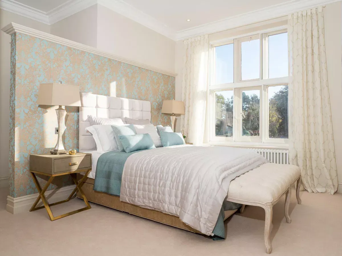 Milverton Hall, A bedroom with a bed , nightstand , lamps and a window.