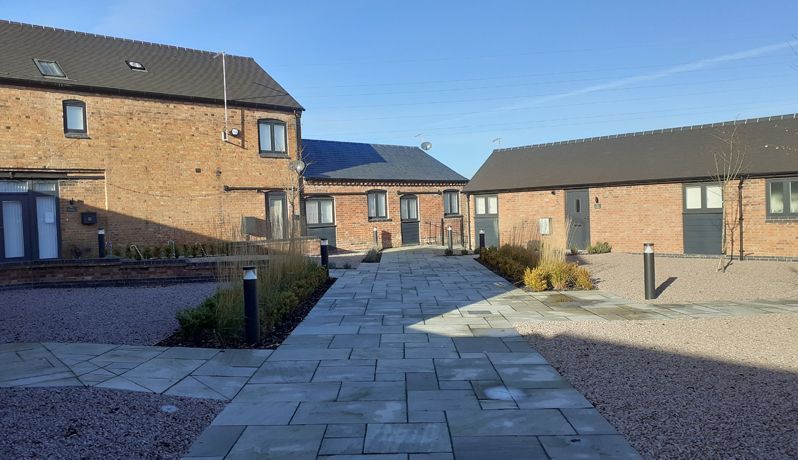 Newbold Farm,  A row of brick houses with a walkway between them.