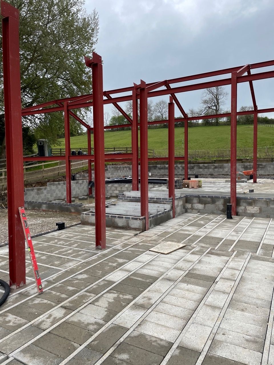 Kingfisher Barn, A large metal structure is being built in a field.