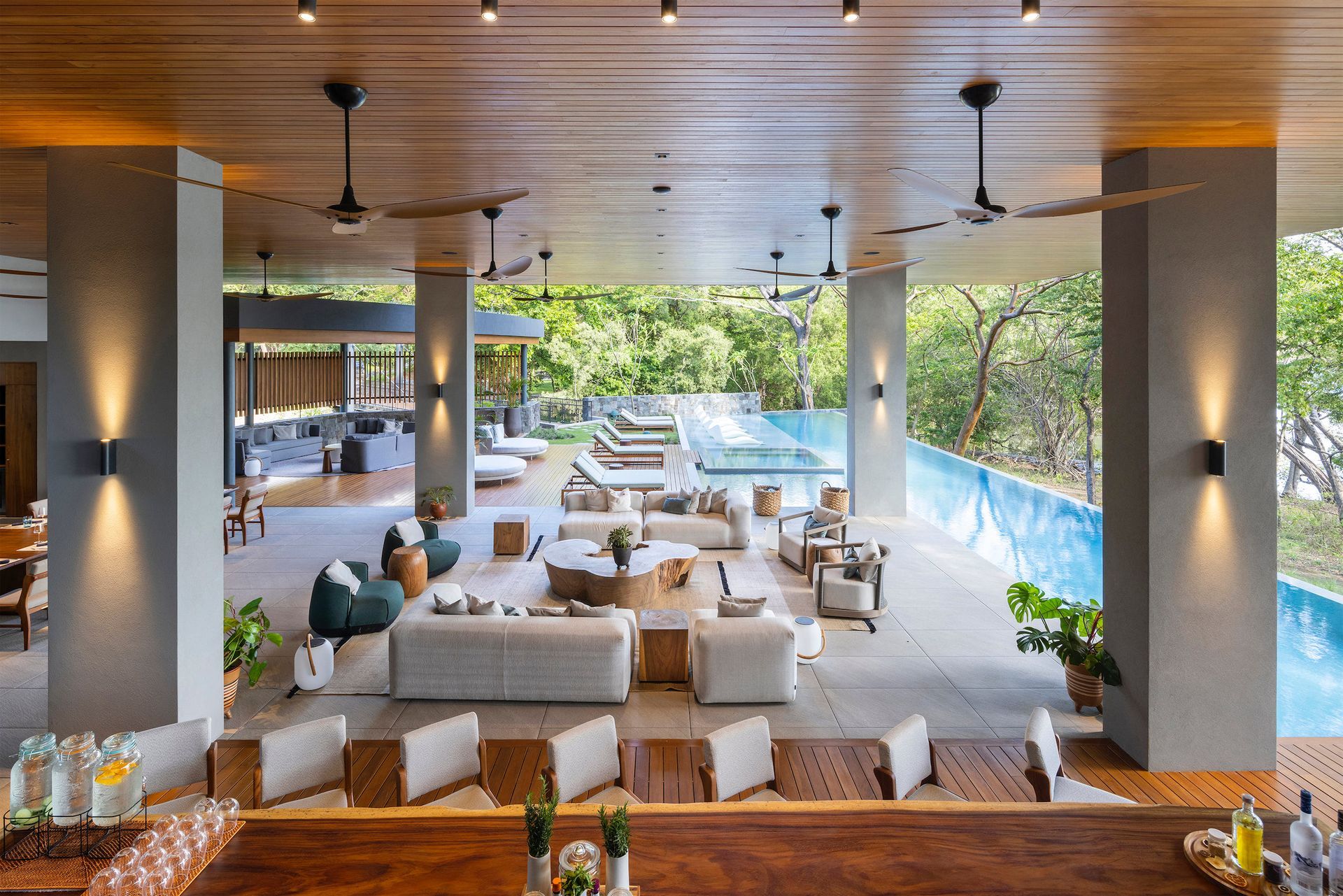 A large room with a lot of furniture and a swimming pool.