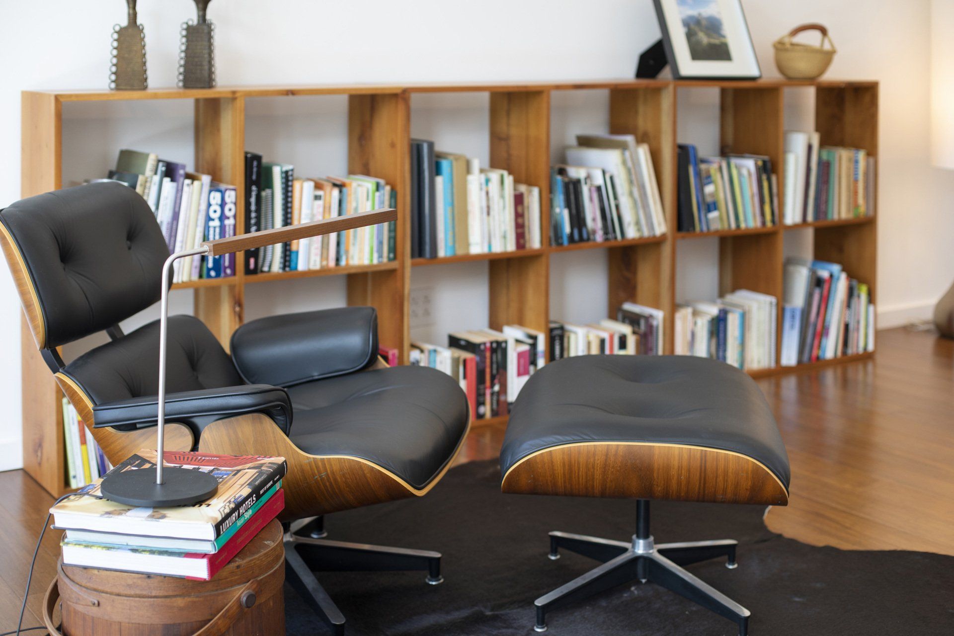 a chair and ottoman in front of a bookshelf filled with books - casa aramara by sarco