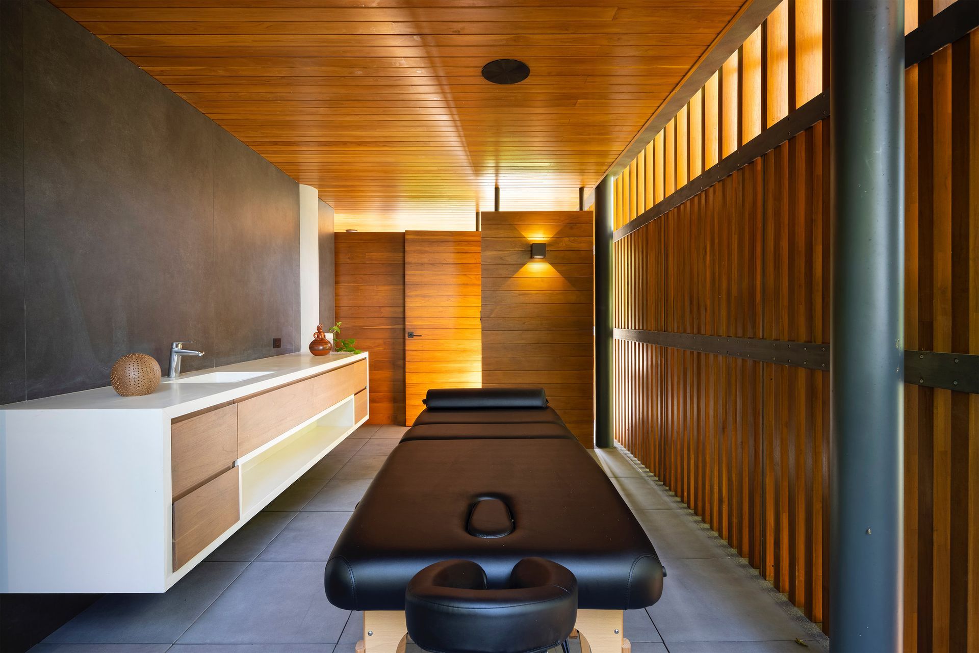 there is a massage table in the middle of the room .