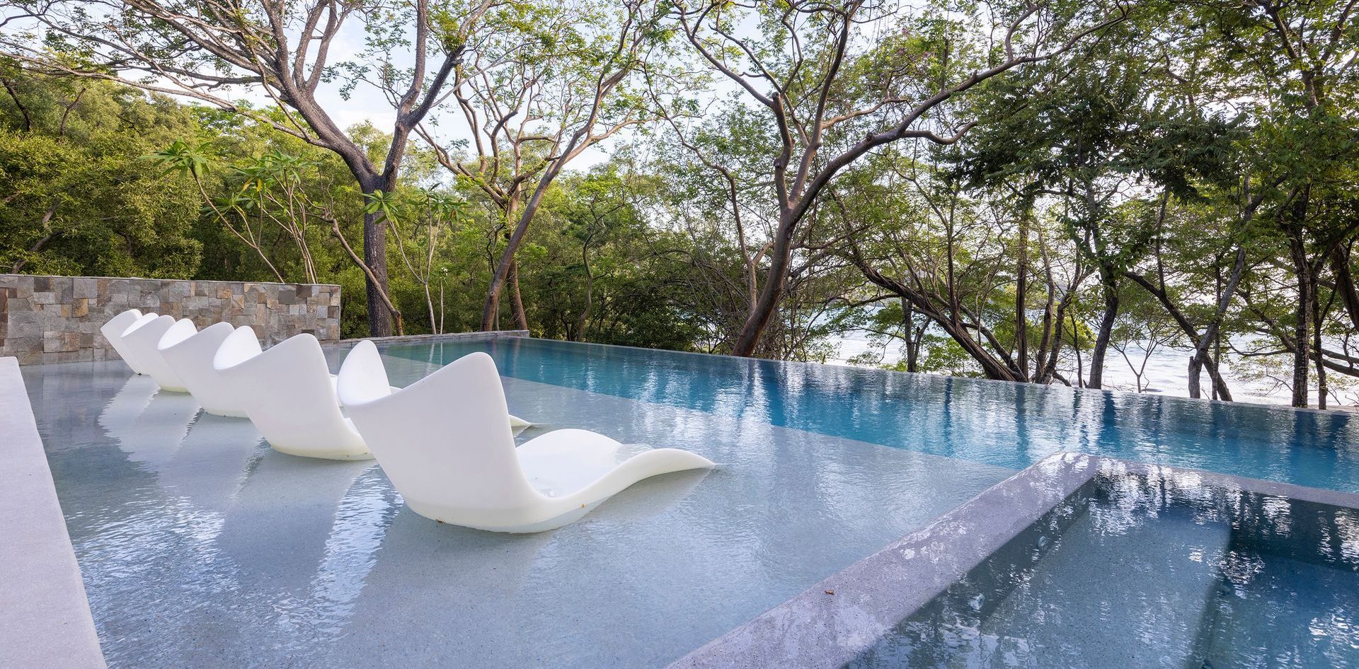 a swimming pool with a lot of chairs in it