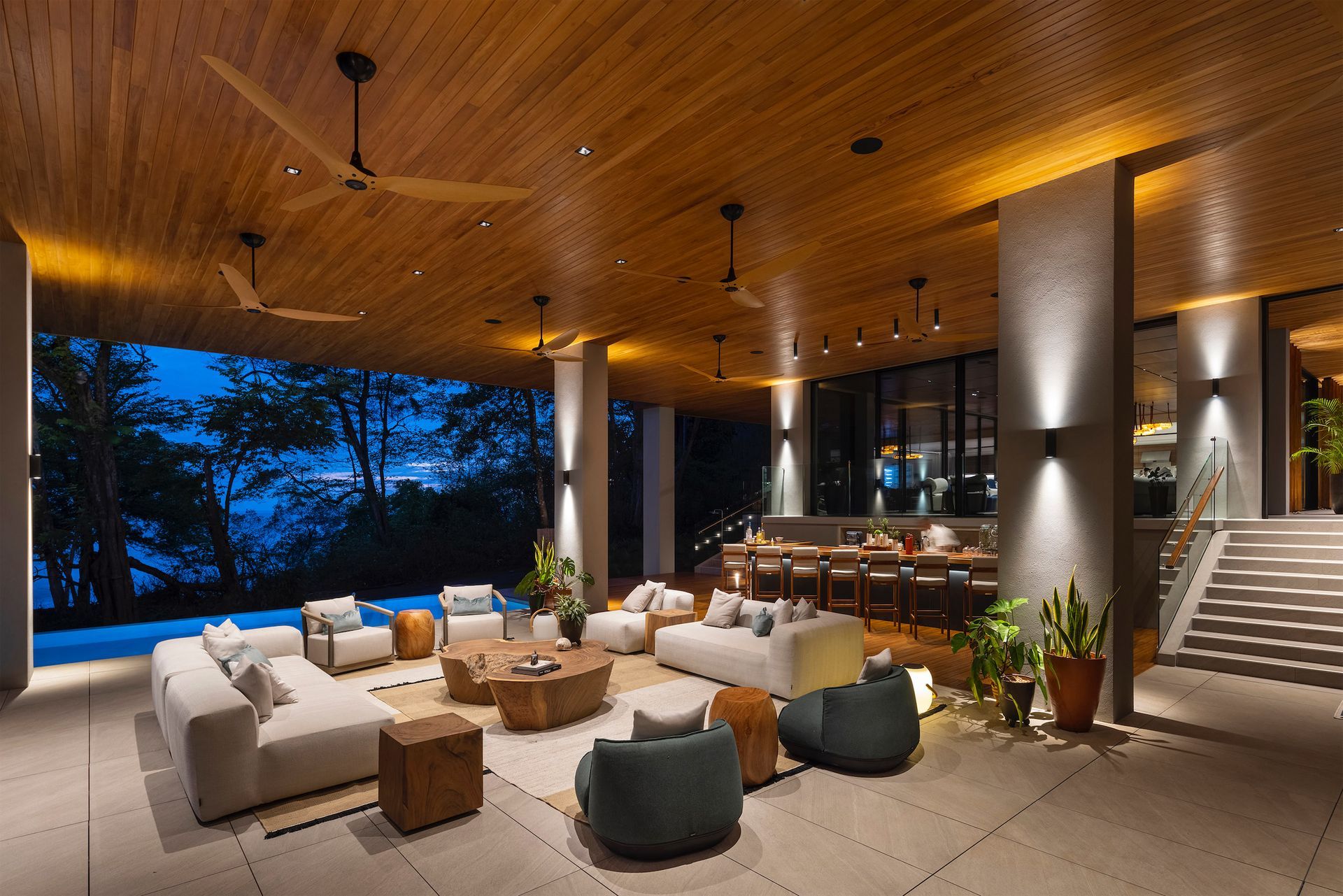 a living room with a lot of furniture and a swimming pool