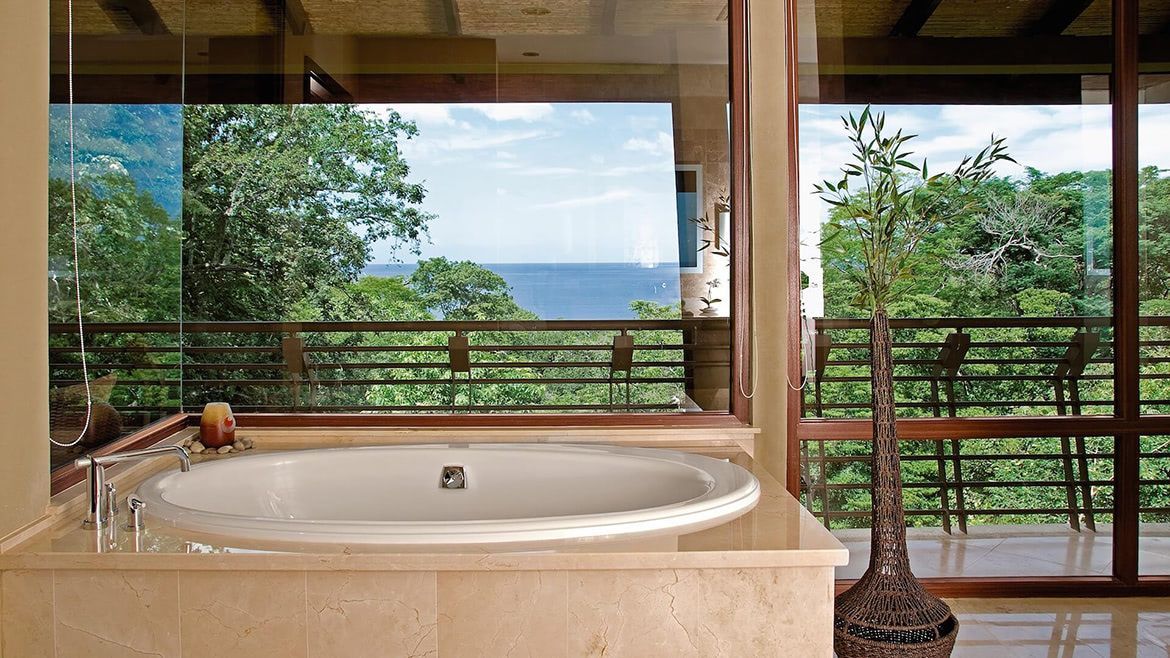 a bathtub in a bathroom with a view of the ocean
