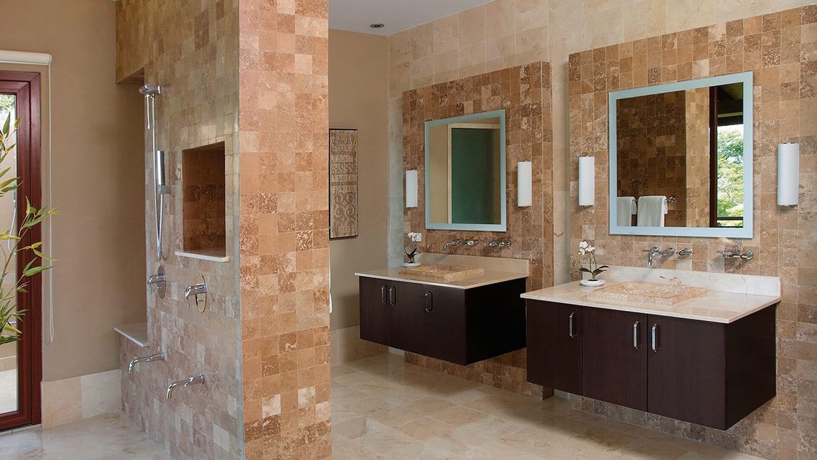 a bathroom with two sinks and two mirrors